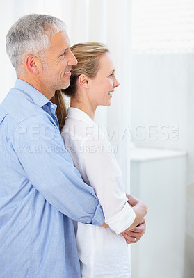 Buy stock photo Senior couple, hug and love for trust, support or care in happy relationship together at home. Mature man hugging woman smile in embrace, bonding or romance on holiday weekend or morning at house