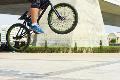 Buy stock photo A BMX rider doing tricks out in the city