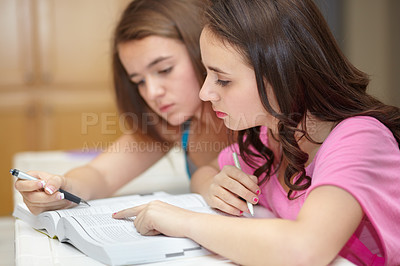 Buy stock photo Two girls sitting together and studying