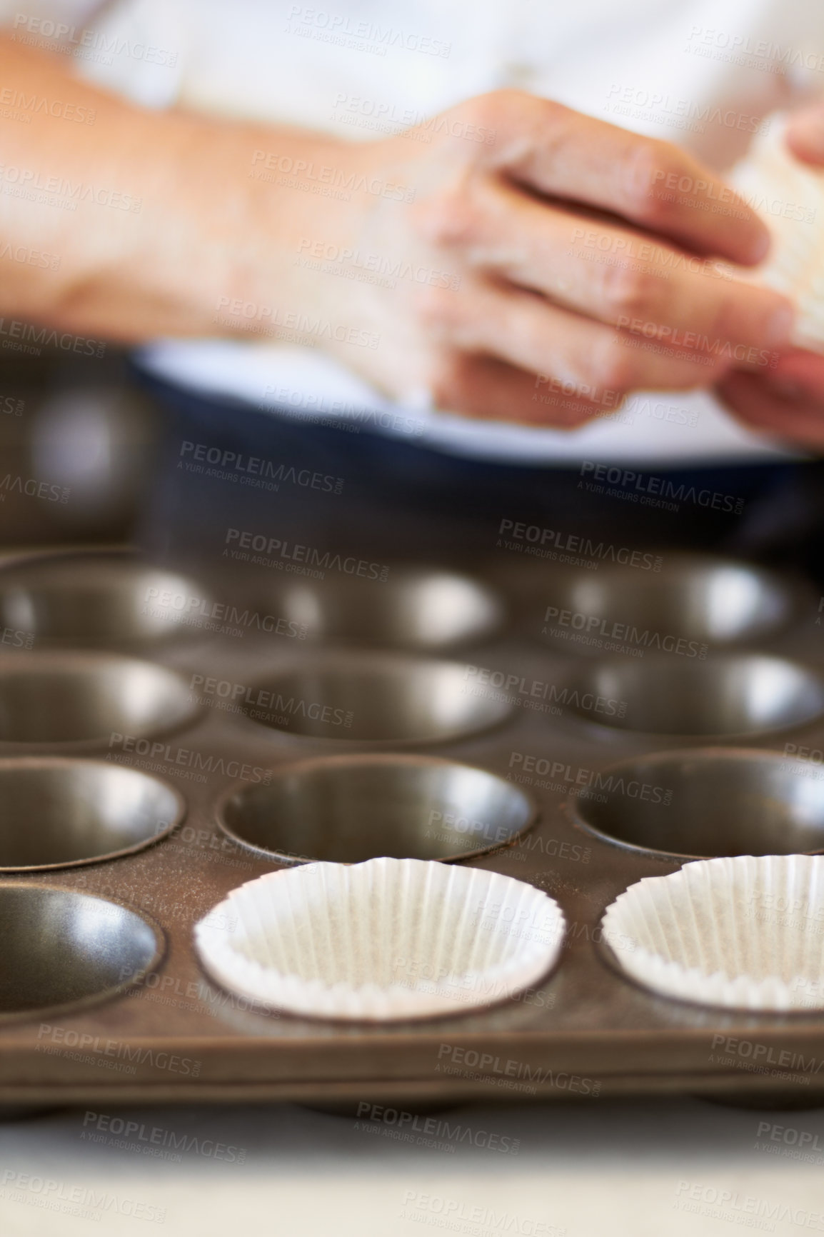 Buy stock photo Cupcake tray, person hands and baking in kitchen with muffin wrapper and cooking closeup in bakery. Prepare, paper cup and food with chef in restaurant, coffee shop or cafe with sweet cake or pastry