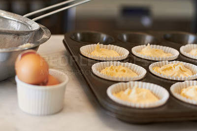 Buy stock photo Cupcake tray, batter and baking in a kitchen with muffin mix or wrapper and cooking in a bakery. Closeup, paper cup and food with chef in a restaurant, coffee shop or cafe with sweet cake and pastry