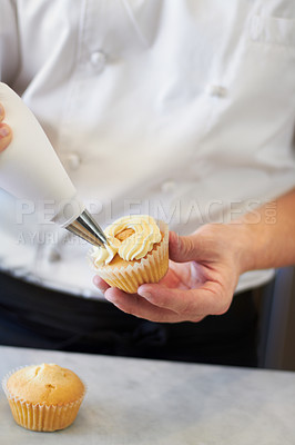 Buy stock photo Closeup baker hands, frosting and cupcake for decoration, dessert and cooking with professional chef. Bakery, cream and muffin on table for restaurant, cafe or coffee shop with food for breakfast