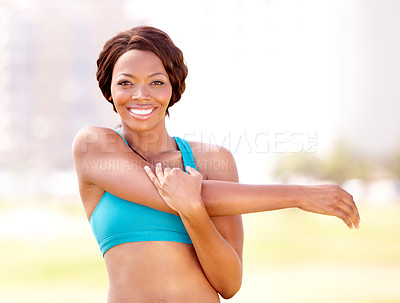 Buy stock photo Happy, portrait and black woman stretching arm outdoor for running, training and workout on blurred background. Face, smile and arm stretch by African lady runner in a park for warm up or fitness run