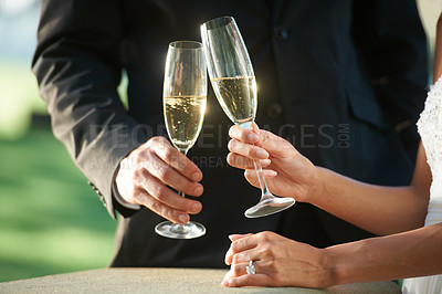 Buy stock photo Hands, couple and toast with champagne, marriage and celebration or event. Newlyweds, people and relax at outdoor ceremony, commitment and cheers in nature, wedding and solidarity or unity at party