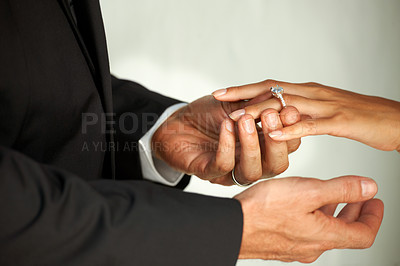 Buy stock photo Couple, bride and ring on hand, commitment and love at wedding, promise and loyalty in marriage. Newlyweds, jewelry and faith or trust in relationship, hope and partnership in closeup of support