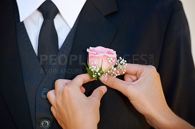 Buy stock photo Cropped image of a groom getting his boutonniere adjusted before the wedding ceremony