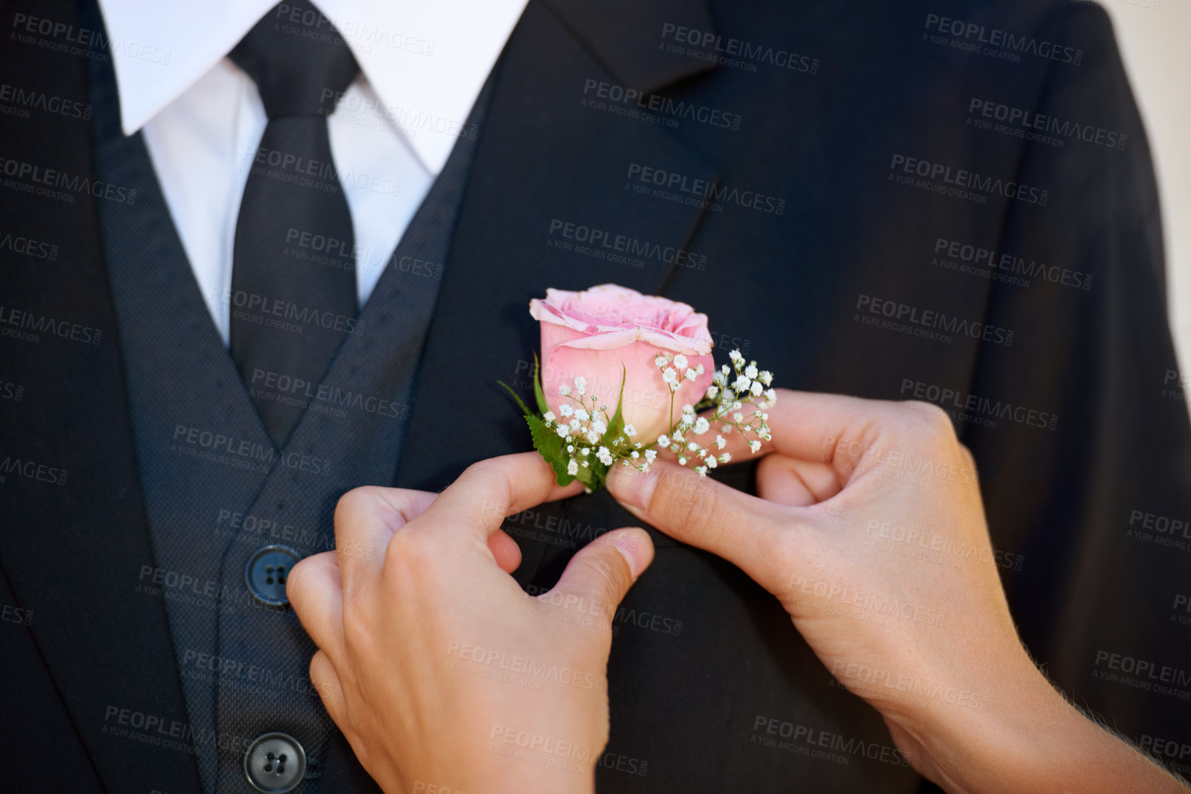 Buy stock photo Cropped image of a groom getting his boutonniere adjusted before the wedding ceremony