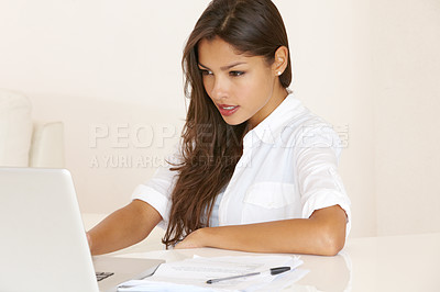 Buy stock photo Young woman working at her laptop
