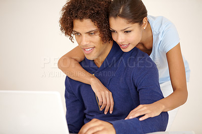 Buy stock photo Hug, happy and couple on laptop for online shopping, browse internet and social networking together. Dating, love and man and woman embrace on computer for reading website, streaming service and blog