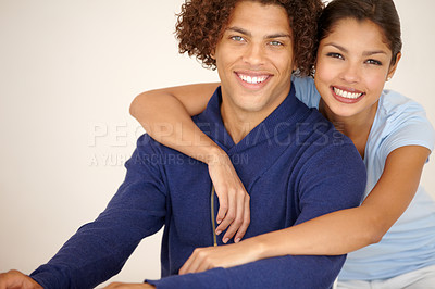 Buy stock photo Gorgeous mixed race couple  smiling affectionately for the camera