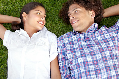 Buy stock photo Love, happy and couple relax on grass outdoors for bonding, loving relationship and weekend. Dating, nature and above of man and woman together in garden for romantic picnic, holiday and vacation