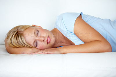 Buy stock photo Home, relax and woman on a couch, sleeping and resting with weekend break, peaceful and calm. Person on a sofa, apartment and girl with fatigue, feeling tired and afternoon nap in a living room