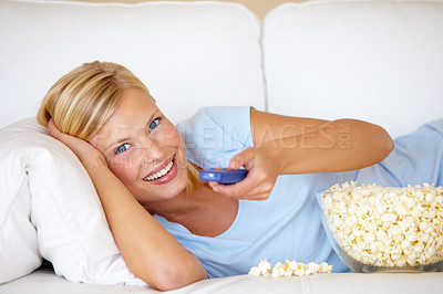 Buy stock photo Portrait, home and watching tv with woman, popcorn and remote with happiness, relax and cheerful. Face, person and girl on a sofa, snack and streaming a movie with joy, film or comedy with television