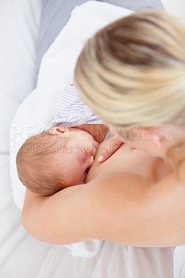 Buy stock photo High angle shot of a mother breastfeeding her newborn baby