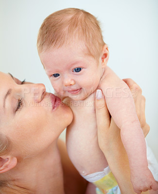 Buy stock photo Mother, family and kiss baby with love for trust, care support and health wellness for parent happiness. Woman, smile or cute newborn with blonde hair, blue eyes or gratitude connect or mama bonding