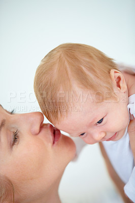Buy stock photo Mother, forehead and kiss baby with love for relax, care support and health wellness with parent happiness. Woman, holding and newborn with blonde hair, gratitude and security trust of maternal bond