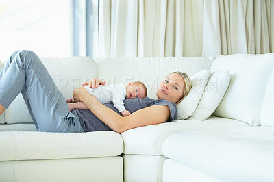 Buy stock photo Relax, home and sofa, mother and baby bonding, woman and kid lying in living room together. Calm morning, mom and newborn on couch for rest, love and family security, comfort and child care in lounge