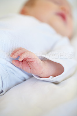 Buy stock photo Closeup, baby or new born with hand on bed for love, caring and support in home. Infant, hope and milestone for future, growth or child development with trust for bonding, protection and security