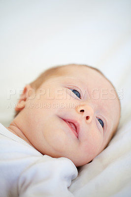 Buy stock photo Closeup, baby and face for wake up on bed from good dream, sleep or nap in nursery. Infant, looking and relaxing on pillow for child growth, cognitive and development in hope for milestone of future