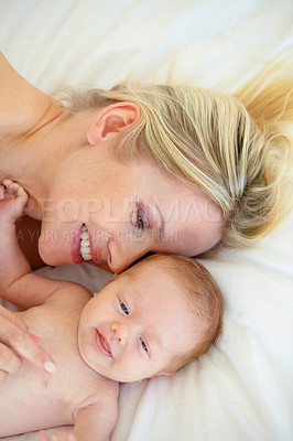 Buy stock photo Relax, laugh and bed, mother and baby bonding, woman and kid lying in home together. Calm morning, mom and newborn in bedroom for rest, love and happy family growth, comfort and child care from above