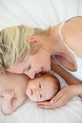 Buy stock photo Relax, bed and mother holding baby, bonding with woman and kid lying in home together. Calm morning, mom and newborn in bedroom for rest, love and support in growth, comfort and child care from above