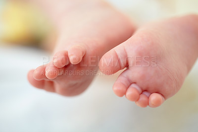 Buy stock photo Closeup, baby and feet for hope in home for future, childhood or development. Infant, toes or growth for milestone with family, care and protection for safety in nursery for wellness, peace or health