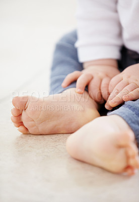 Buy stock photo Closeup, feet and baby on floor in home for child development, health and growth. Family, youth and adorable toes and hands of young infant in living room for wellness, learning to crawl and relax