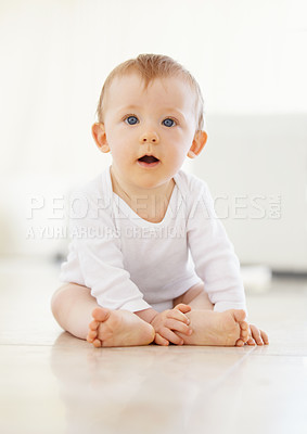 Buy stock photo Shot of an adorable little baby sitting on the floor