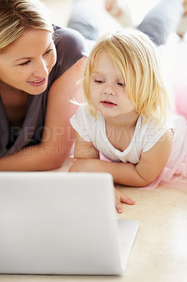 Buy stock photo A little girl and her mother using a laptop