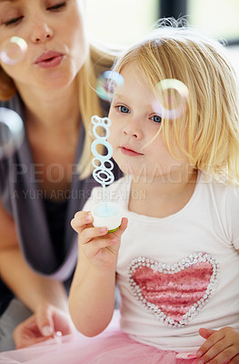 Buy stock photo Blow, bubbles and games with mom and child together in home playing with toys for fun. Playful, mother and girl with liquid, soap and bonding on holiday, vacation or relax on weekend with love