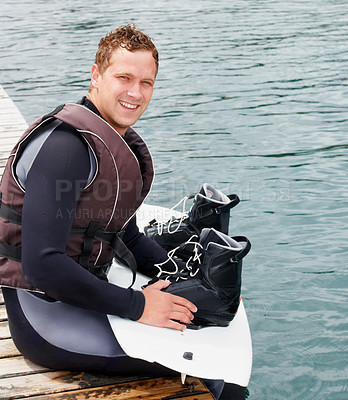 Buy stock photo Lake, fitness and portrait of man with wakeboard for surfing, exercise and recreation hobby outdoors. Equipment, extreme sports and person with board for water skiing for freedom, adventure and fun