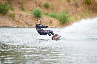 Buy stock photo Nature, wakeboarding and adventure, man on lake with outdoor fun, fitness and wave splash. Balance, water sports and person on river with freedom, speed and energy for surfing challenge, ski and sun.