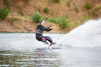 Buy stock photo Spray, wakeboarding and adventure, man on lake with outdoor fun, fitness and wave splash. Balance, water sports and person on river with freedom, speed and energy for surfing challenge, ski and trick