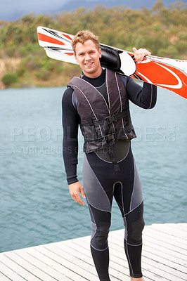 Buy stock photo Water ski, portrait and man by lake with wakeboard for surfing, exercise and recreation hobby outdoors. Fitness, extreme sports and excited person with board for skiing for freedom, adventure and fun