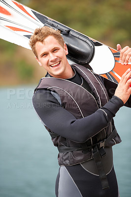 Buy stock photo Sports, portrait and man by water with wakeboard for surfing, exercise and recreation hobby by lake. Fitness, extreme sport and excited person with skiing board for freedom, adventure and outdoor fun