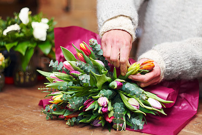 Buy stock photo Cropped shot of a florist&#039;s hands preparing a bouquet