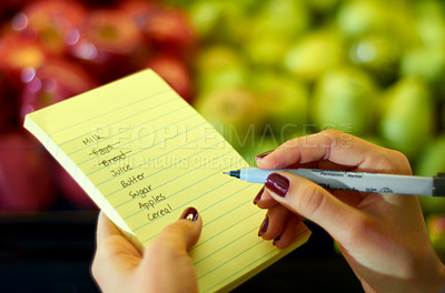 Buy stock photo Cropped image of a woman's hand holding a shopping list