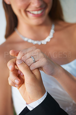 Buy stock photo Couple, wedding ring and hands together in marriage with bride and smile at celebration and trust event. Flower, loyalty and care with romance and jewelry with love and commitment with woman and man