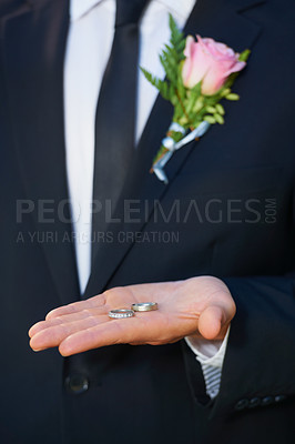 Buy stock photo Groom, hand closeup and ring for wedding, ceremony or celebration in suit, flowers and event. Person, palm and metal jewelry for marriage, party or commitment to relationship, engagement or proposal