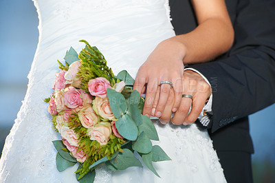 Buy stock photo Couple, wedding ring and hands with bouquet in marriage with bride at celebration and trust event. Flower, loyalty and care with romance and jewelry with love and commitment with woman and man