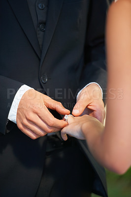 Buy stock photo Couple, hands and wedding ring for marriage, commitment or promise in love, care or trust and support at ceremony. Closeup of married man putting jewelry on bride for loyalty, proposal or engagement 