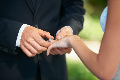 Buy stock photo Couple, hands and wedding ring for proposal, commitment or promise in love, care or trust and support at ceremony. Closeup of married man putting jewelry on bride for loyalty, marriage or engagement