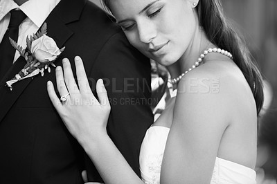 Buy stock photo Black and white image of a beautiful bride embracing her husband from behind lovingly