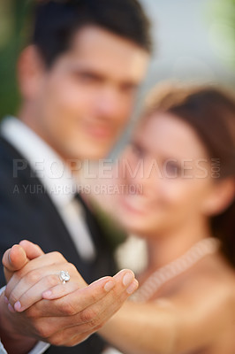 Buy stock photo Hands, ring and a couple on their wedding day for love, romance or celebration at a marriage ceremony. Trust, commitment or promise with a bride and groom together at an event to get married closeup