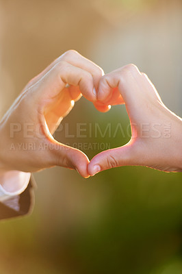 Buy stock photo Closeup of a newlywed couple making a heart with their hands on their wedding day
