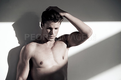 Buy stock photo Young attractive man, muscle and posing with no shirt standing isolated against a wall background. Handsome male person or muscular model with hair in beauty, grooming or style with body and shadows