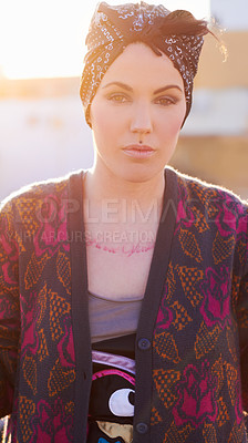 Buy stock photo Portrait, fashion and serious woman in city with scarf on head, urban tattoo and stylish. Face, street and trendy female person from Norway in cool clothes, attitude and body art outdoor at sunset.