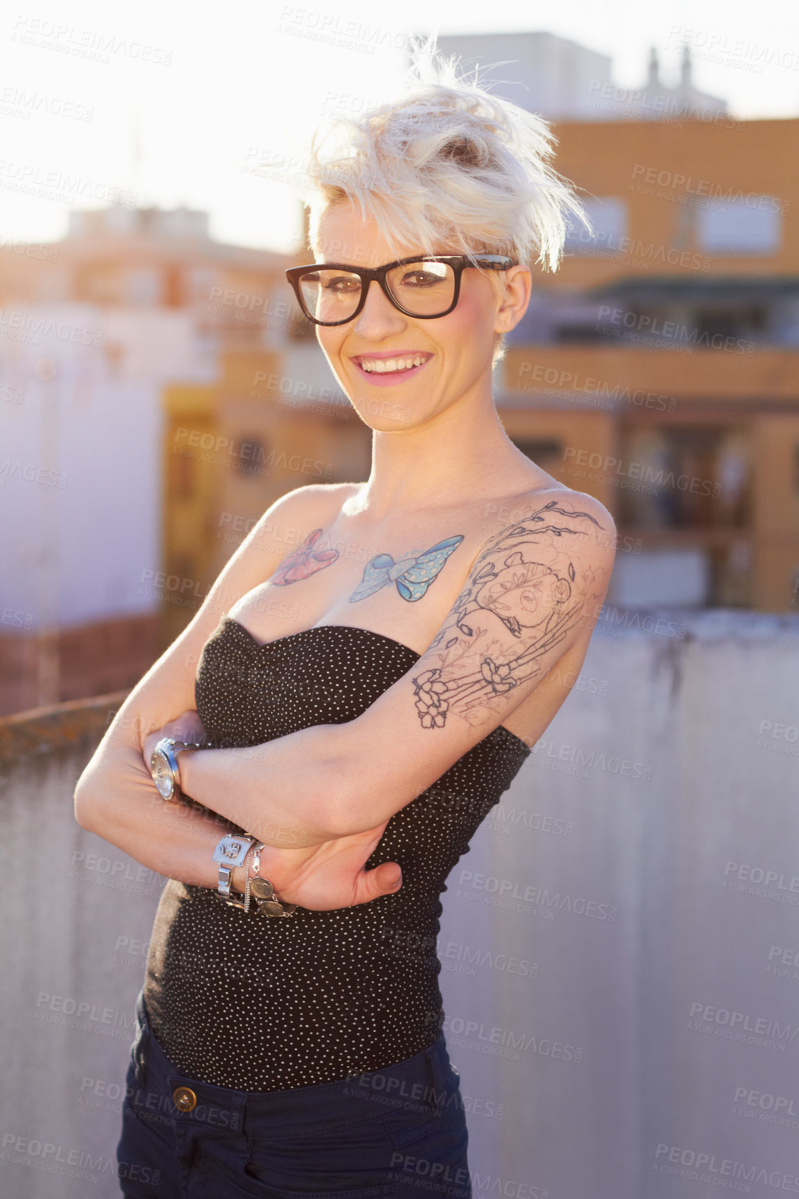 Buy stock photo Glasses, portrait and woman in city with arms crossed for stylish tattoo, body art and fashion. Hipster, street and confident female person standing outdoor in Australia, happy and punk attitude.