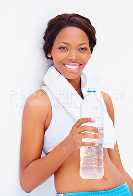 Buy stock photo Black woman, exercise and water with portrait and smile from sport, workout and training in studio. Happy, healthy and African female athlete with wellness and drink after gym with white background