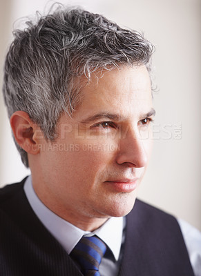 Buy stock photo A handsome mature businessman looking away thoughtfully